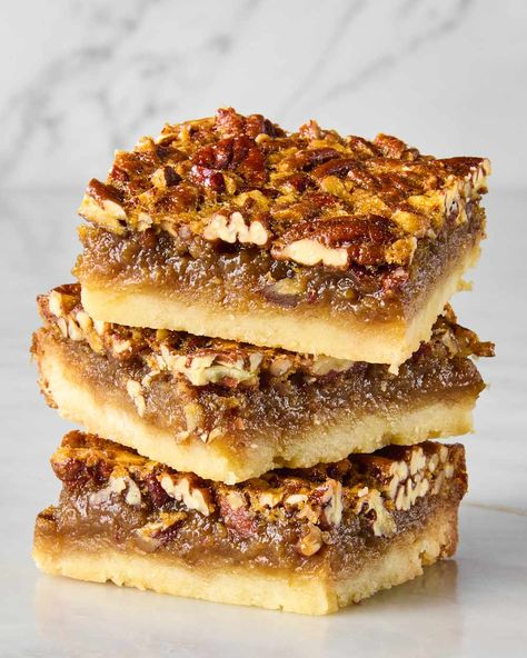 head on shot of three pecan pie bars stacked on each other Weird Thanksgiving, Easy Pecan Pie Bars, Pecan Bars Recipe, Pecan Pie Bars Easy, Easy Pecan Pie, Pecan Pie Bars Recipe, Thanksgiving Dessert Ideas, Pecan Pie Muffins, Shortbread Cookie Crust