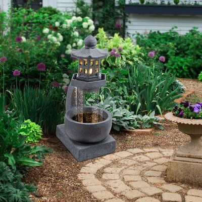 Bring tranquility to your outdoor space with the pagoda fountain. This decorative fountain features water raining down from a zen pagoda top into the stone bowl below with an interior pump that keeps the water flowing - just plug it in! This unique fountain features four LED lights on the pagoda top and four LED lights in the bowl to provide a dramatic effect. It is great for adding a calming ambiance to your backyard, front lawn, patio, porch, courtyard, entryway, and more. The tranquil sounds Japanese Garden Fountain, Bird Bath Ideas Front Yards, Front Courtyard Ideas Entryway, Mechanical Crafts, Courtyard Design Ideas, Courtyard Entryway, Buddha Zen Garden, Backyard Fountain, Patio Fountain