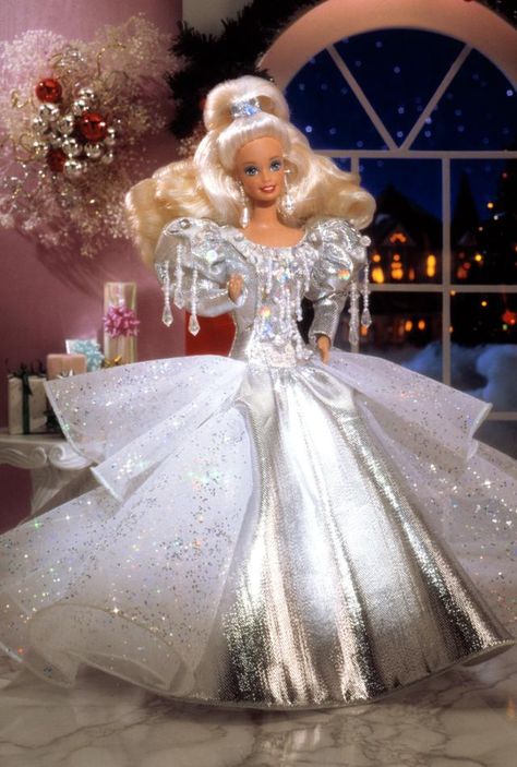 Special Edition   Release Date: 1/1/1992    Barbie® is ready for the holiday season, dressed in a luxurious, silver lamé gown. The many layers of her tulle skirt are accented with holographic glitter, and shimmering beads dangle from the bodice. Silvery earrings and a silvery "jewel"-accented hairband create the finishing touches to this festive ensemble. Happy Holidays Barbie, Barbie Bride, Christmas Barbie, Barbie Gowns, Bride Dolls, Im A Barbie Girl, Holiday Barbie, Barbie Vintage, Bob Mackie