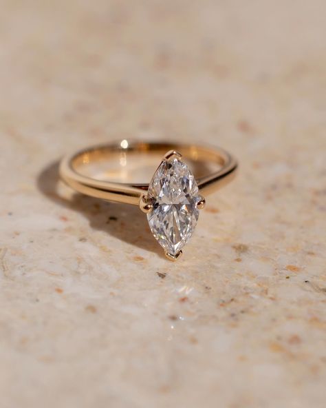 Fun fact - because of their cut, marquise tend to look bigger than their carat weight ✨ This gorgeous solitaire style features a lifted cathedral setting to allow for a straight wedding band to sit flush. Details: - 1.28ct marquise diamond - 14k yellow gold - 1.8mm wide shank #marquiseengagementring #nz #labgrowndiamond #customengagementring #aus Gold Marquee Engagement Ring, Wedding Ring Marquise, Yellow Gold Anniversary Rings, Engagement Ring Classic, Bride Birthday, Marquise Cut Rings, Anniversary Rings For Her, Marquise Diamond Ring, Ring Proposal