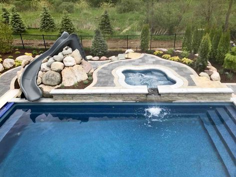 Fiberglass Pool, Water Slide, Auto Pool Cover Natural Stone Oasis Project in Northville, Michigan by Antonelli Landscape Pool & Spa Pool With Slide And Hot Tub, Rectangle Pool With Spa And Fire Pit, Pool With Slide And Waterfall, Modern Pool With Slide, Pool With Slide, Fiberglass Pool Ideas, Stone Pool Deck, Pool Water Slide, Automatic Pool Cover