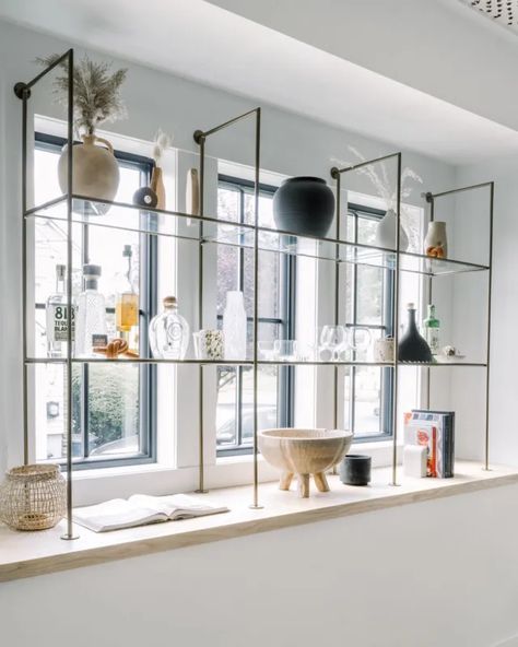 Shelving Across Windows, Bar Shelves In Front Of Window, Bar With Windows Behind, Window Display Shelves, Steel Shelves Design, Glass Shelves In Front Of Window, Diy Glass Shelves, Shelves In Front Of Window, Tiffani Faison