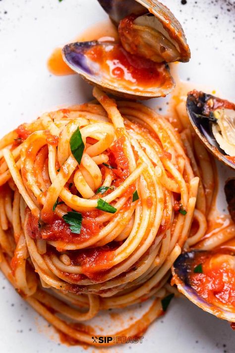 Linguine with red clam sauce is perfect for any time of year but especially great as one of the seven fishes. Littleneck clams and al dente pasta are tossed in a tomato and white wine sauce flavored with garlic and anchovy and topped with fresh parsley. #clams #Italianfood #clamsauce Clam Tomato Pasta, Spicy Clam Pasta, Clams In Red Sauce Pasta, Pasta With Red Clam Sauce, Red Sauce Seafood Pasta Recipes, Pasta Clam Sauce, Linguini With Red Clam Sauce, Red Clam Sauce With Canned Clams, White Wine Tomato Pasta Sauce