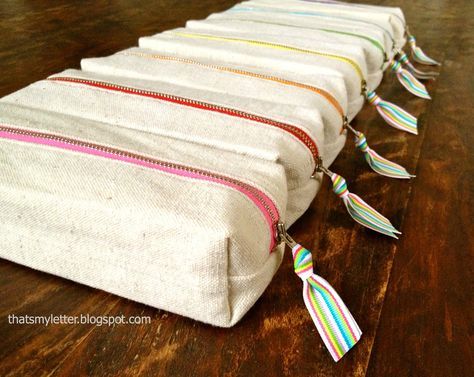 Sew: boxy pencil pouches Easy to sew boxy drop cloth canvas pencil pouches with rainbow print lining and rainbow colored zippers. These pencil pouches are part of a party favor. I made these pencil holder party favors and then started thinking about how the girls would transport their favors home? Solution: boxy pencil pouches: I used... Read more Pencil Pouch Diy, Pencil Case Tutorial, Pencil Case Pattern, Pencil Pouches, Diy Pencil Case, Zipper Pencil Case, Diy Pencil, Pouch Diy, Pouch Tutorial