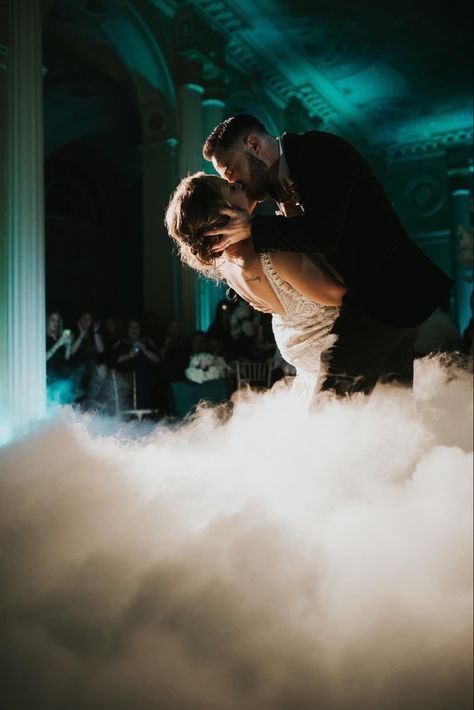 Groom gently dips his beautiful bride and kisses her during their first dance while they’re engulfed in clouds. First Dance Photography, Bride And Groom Dance, Wedding Uplighting, Uplighting Wedding, First Dance Photos, Wedding Ceremony Ideas, Wedding Lighting, Sand Ceremony, Dry Ice