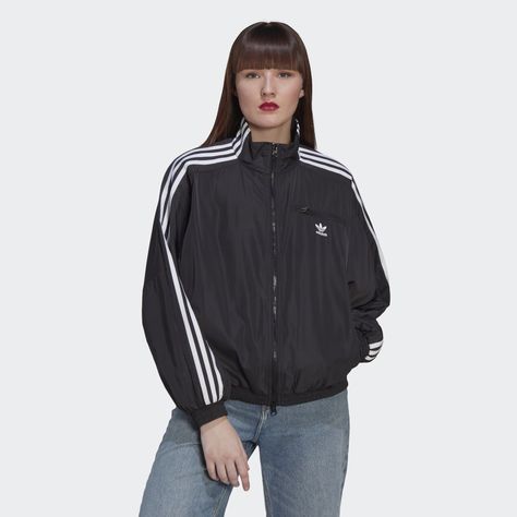 From the pitch to your closet. The adidas track jacket has covered a lot of ground over the decades, transforming from a piece of athletic gear to a style icon. Wherever it shows up, it's always fresh. Pair this modern take with sweats, a dress or a skin-tight bodysuit, and play with the two-way zip to make the look your own.Made with 100% recycled materials, this product represents just one of our solutions to help end plastic waste. Black Adidas Jacket, Sporty Jacket, Adidas Track Jacket, Athletic Gear, The Pitch, Jogging Bottoms, Adidas Track, Adidas Hoodie, Tights Outfit