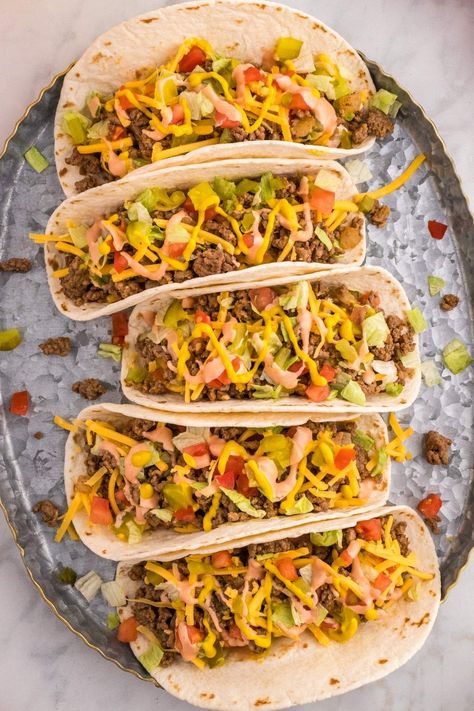 If you can't decide whether you're in the mood for a cheeseburger or you want to have tacos for dinner, why not combine both ideas and make a fusion dish? These cheeseburger tacos offer the best of both worlds - the hearty goodness of cheese-topped burgers with all your favorite burger toppings, served in tortillas. You could even set up your own taco station so everyone can help themselves to their chosen toppings and garnishes. Make this for Taco Tuesday and there's no way you'll regret it! Big Mac Cheeseburger, Cheeseburger Tacos, Mexican Rice Pudding, Taco Station, October Recipes, Tacos For Dinner, October Food, Tacos Recipes, Tortilla Shells