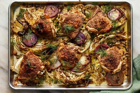 This hearty one-pan meal is inspired by the classic combination of sausage and sauerkraut, but with chicken in place of pork and fresh cabbage instead of fermented Cabbage slices are brushed with a simple mustard vinaigrette, then roasted underneath chicken thighs that have been seasoned with cumin and coriander In the heat of the oven, the chicken crisps, the cabbage softens and the red onion becomes jammy and sweet Chicken Crisps, Hearty Stew, Roast Fish, Chicken And Cabbage, Sheet Pan Suppers, Fermented Cabbage, Roasted Cabbage, Nyt Cooking, Pan Chicken