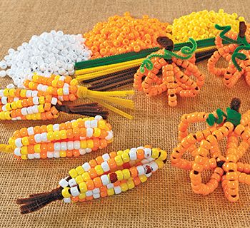 Pony Bead Corn & Pumpkins – Colorations® Pony Bead Corn Cob, Pumpkin Bead Craft, Pony Bead Pumpkins, Fall Pony Bead Crafts, Bead Corn Craft, Beaded Corn Craft, Pony Bead Halloween, Fall Festival Craft Ideas, Thanksgiving Placemats Kids