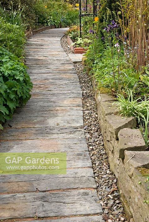 Concrete railway sleeper path edged with pebbles and stone wall at 69 Well Lane, NGS garden, Cheshire Wood Path Garden, Wood Pathway Ideas, Rustic Garden Path, Sleeper Path, Budget Backyard Landscaping, Landscape On A Budget, Backyard Walkways, Railway Sleepers Garden, Landscaping Backyard Ideas