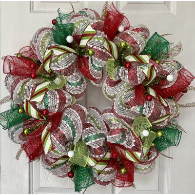 Full, Premium handmade deco mesh Christmas Wreath. This wreath is made of white snowdrift deco mesh with shimmering stripes. The center ring has metallic red and metallic green mesh ribbons along with festive white ribbons with glittering Christmas dots. The outer ring has shimmering red and green deco mesh flutes and red, green, and white flex ribbons. Very Christmas ribbons are placed all over! Available in 24-inch diameter. the depth is 6 inches. Metallic green tinsel ties with shiny red ball Deco Mesh Christmas Wreath, Mesh Christmas Wreath, Green Tinsel, Deco Mesh Wreaths Diy, Wreath Indoor, Mesh Wreath Diy, Deco Mesh Christmas Wreaths, Christmas Mesh Wreaths, Red Ornaments