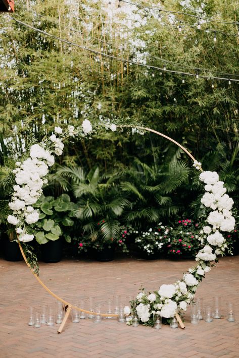 Simple Classic Outdoor Bamboo Courtyard Wedding Decor, Hanging Bistro Lights, Round Circular Gold Metal Arch with Lush White and Greenery Flowers | St. Pete Wedding Florist Save the Date Florist | Wedding Venue NOVA 535 Round Arch Decoration Wedding, Bamboo Courtyard, St Pete Wedding, Greenery Flowers, Courtyard Wedding, Wedding Alters, Metal Wedding Arch, Industrial Wedding Venues, Bistro Lights