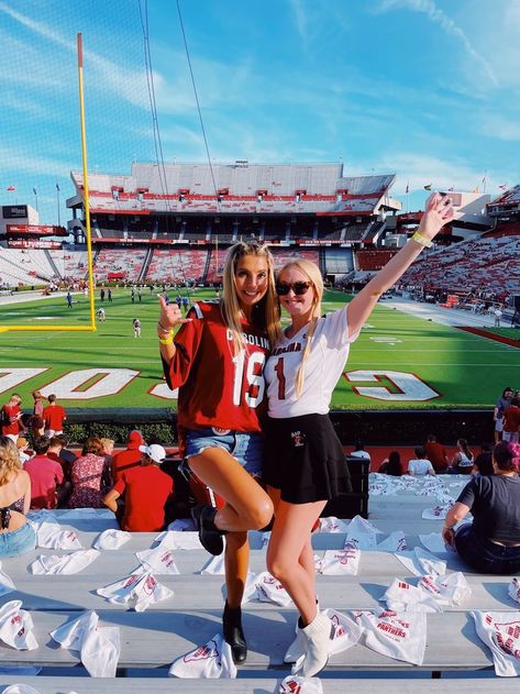 University of South Carolina Gameday Outfit Inspo | College Tailgate | Football Jersey | Gamecocks , college gameday , SEC , sorority girl , sorority life , greek life , UofSC , football field , best friends poses , jersey outfit , garnet , black , white , blonde hair , pretty sky , tailgate , fall fashion , Saturday, white boots , black boots , jean shorts , sorority pin Gamecocks Outfit, Usc College, Girly Games, College Tailgate, College Gameday Outfits, College Tailgating, Football Jersey Outfit, White Blonde Hair, Football Tailgate