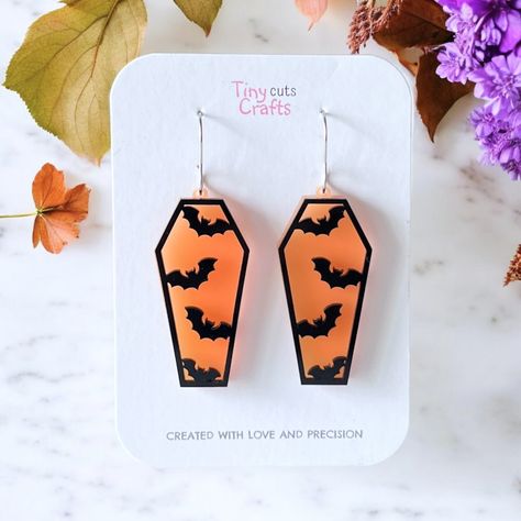 Goth Halloween coffin bat earrings. Each earring features an orange coffin with black bats layered on top, creating a striking and spooky look. Measuring between 2.25" to 2" in length and 0.80" in width, these earrings are the perfect accessory for Halloween parties or as a festive gift for bat enthusiasts. Crafted with stainless steel findings for durability and hypoallergenic properties, they ensure comfort and longevity.  Arriving in a gift bag accompanied by a polishing cloth, these earrings Halloween Earrings Diy, Halloween Jewellery, Shrinky Dink Jewelry, Vampire Earrings, Earrings Goth, Apple Watch Bands Fashion, Glow Forge, Halloween Clay, Halloween Coffin