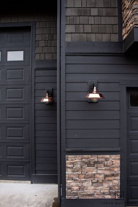 Dark Home Exterior Makeover with copper sconces Black Brick House Exterior Color Combos, Exterior Wall Lighting Design, Light Brown Exterior House Colors, Unique Siding Ideas Exterior, Dark Brown Siding Exterior, Dark Craftsman Exterior, Dark Brown Brick House Exterior, Brown Home Exterior, Home Makeover Exterior