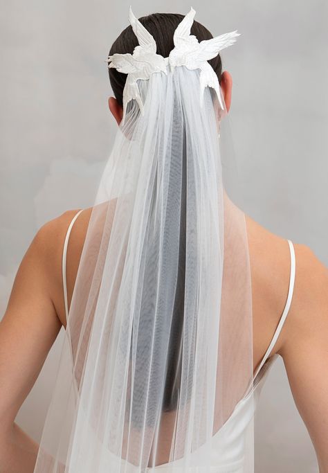 The chapel length Avain Veil is the perfect statement-making accessory for the daring romantic bride. Beautifully embroidered birds frame the back of the head as they 'kiss' while a soft layer of oyster tulle cascades down from underneath them. The veil effortlessly slides into the back of your hairstyle with a metal comb. Styled here with the Lipsy Gown. Cool Bridal Jewelry, Wedding Veils Unique, Non Traditional Veil, Veil Hairstyles Hair Down, Unique Veils Wedding, Wedding Veil Alternatives, Ethereal Hairstyles, Wedding Veil Hair, Wedding Veil Ideas