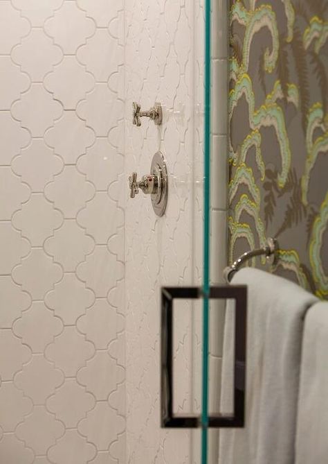 Behind a glass door, a walk-in shower is fitted with large white arabesque wall tiles. Arabesque Tile Shower Wall, Arabesque Shower Tile Ideas, Arabesque Tile Shower, White Arabesque Tile, Arabesque Tile Bathroom, Lantern Tile, Shower Tiles, Bathroom Tub Shower, Arabesque Tile