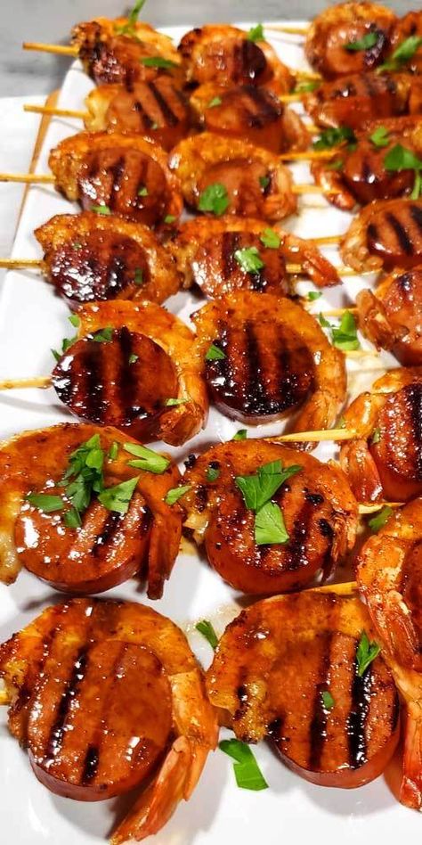 These Glazed New Orleans BBQ Shrimp & Sausage Kabobs are kind of magical because they disappear before your eyes. I'm not kidding I set these out for a party and poof gone, all gobbled up. #creole #NewOrleans #shrimp #sausage #kabobs #appetizers #partyfood Bbq Shrimp And Sausage Skewers, Shrimp And Sausage Kabobs On The Grill, Shrimp Birthday Party, Shrimp And Sausage Appetizer, Seafood Bbq Ideas, Cajun Kabobs, New Orleans Appetizers, Grill Kabobs, New Orleans Bbq Shrimp