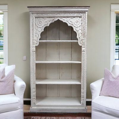 Hand-crafted solid mango wood display bookcase with intricate hand-carved detail. Timeless style, in a whitewashed finish, this piece blends itself well with many interior design style. Four large fixed shelves are the perfect canvas to display your collectibles and organize your space. Fully assembled from solid wood this is a substantial piece that is built to last. Sundara Furnishings Furniture & Home Decor | washed Mango Wood Bookcase brown / Wood in White Sundara Furnishings Furniture & Hom Birdcage Bookcase, Coastal Bookshelf, Perfume Cabinet, Elegant Bookshelf, Romantic Furniture, Bookcase White, 2025 Goals, Upcycle Furniture, Display Bookcase