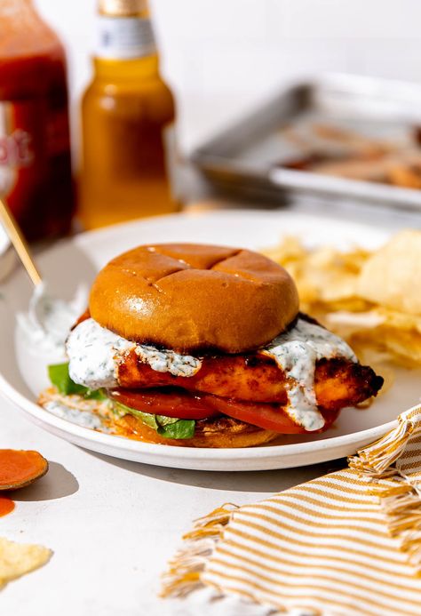 This quick & easy Grilled Buffalo Chicken Sandwich recipe is the perfect summer dinner! Spiced chicken breasts grilled until charred & juicy & finished with homemade buffalo sauce. Serve on brioche buns with an herbed ranch yogurt drizzle & any other buffalo chicken toppers you love. Made in 30 minutes or less, grilled buffalo chicken sandwiches are super quick & delicious! #grilledbuffalochicken #grilledbuffalochickensandwich #buffalochickensandwich #grillingrecipes #grilledchickenrecipes Grilled Buffalo Chicken Sandwich, Easy Homemade Buffalo Sauce, Buffalo Chicken Sandwich, Grilled Buffalo Chicken, Chicken Sandwich Recipe, Buffalo Chicken Wraps, Buffalo Chicken Sandwiches, Homemade Buffalo Sauce, Spiced Chicken