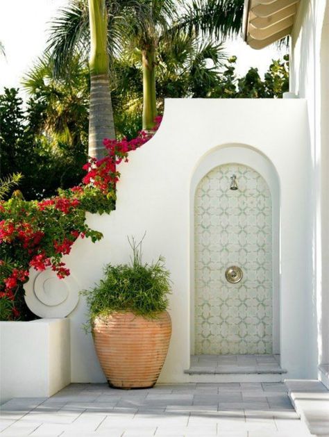 Lovely luxurious tropical white outdoor shower with arched details and large pots. #outdoorshower #lucuryhomes White Exterior Houses, Pregnancy Skincare, Outdoor Bathroom, Paint Color Inspiration, Pintura Exterior, Spanish Style Home, Hacienda Style, Spanish Style Homes, Outdoor Bathrooms