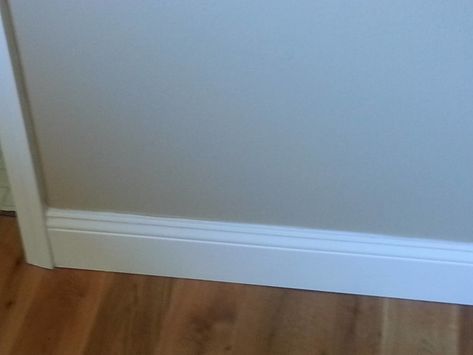 9/16" x 5-1/4" x 8' PFJ Primed Colonial Baseboard | Lumber Liquidators Flooring Co. Colonial Baseboard, White Baseboards, Baseboard Styles, Ll Flooring, Lumber Liquidators, Light Grey Walls, Wall Systems, Wood Dust, Baseboards