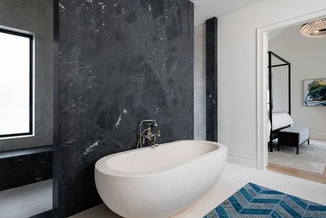 Ensuite bathroom boasts a honed black marble accent wall and an oval tub fitted with a chrome vintage handheld tub filler. Tub Accent Wall, Paint Accent Wall, Marble Accent Wall, Oval Tub, Custom Home Build, Accent Wall Ideas, Diy Storage Rack, Accent Wall Paint, Transitional Bathroom