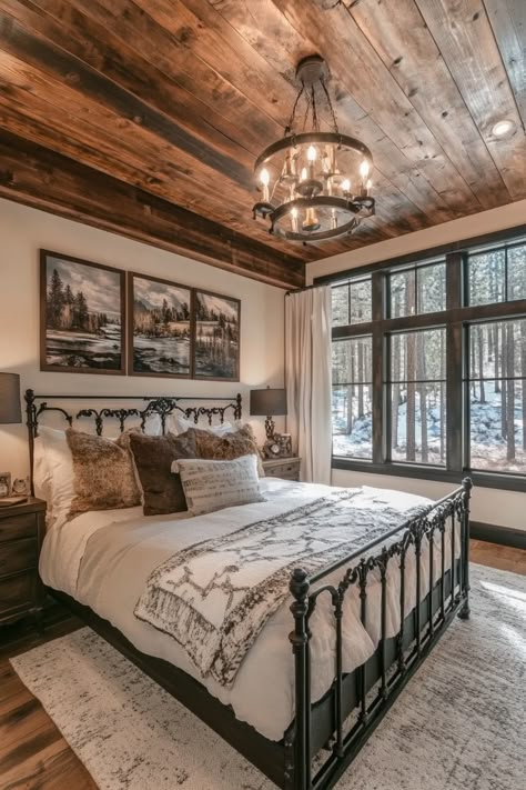 Rustic-chic bedroom. Shiplap ceiling with a distressed black iron frame bed.  Welcome to the latest trend in home design that combines both style and functionality seamlessly - modern farmhouse sleeping spaces with sliding barn doors! This rustic-chic decor has taken the interior design world by storm, promising a unique blend of snug comfort and stylized appeal. You definitely won't be disappointed!…  Read more: https://tastyinteriors.com/generated-post-73-modern-farmhouse-sleeping-spaces-sliding-barn-doors/ Bedroom Ideas Barndominium, Rustic Guest Room Ideas, Log Cabin Master Bed, Barndo Bedroom Ideas, Barndominium Ideas Interiors Bedroom, Barn House Bedroom Ideas, Dream Farmhouse Bedroom, Country Master Bed, Cabin Bedroom Ideas Rustic