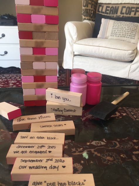 DIY Cute Valentine's Day Gift Game for him. Painted sides of blocks with pinks and reds while leaving a few of the ends raw. Wrote down special dates, places, quotes, fun rules, etc. Fun! I found an old Jenga game and some paint - cheap, easy handmade and so so sweet! :) Jenga Anniversary Gift, Pink Jenga, Jenga Game Diy, Jenga Painting Ideas, Game Ideas For Adults, Board Game Ideas, Places Quotes, Homemade Board Games, Game Day Quotes