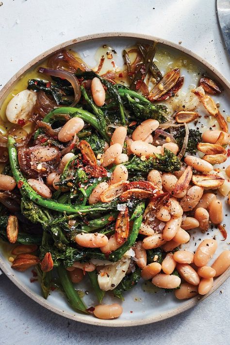 NYT Cooking: This white bean dish isn’t shy when it comes to garlic. It’s used in the pot along with the simmering beans, and also fried in olive oil as a crunchy, pungent garnish. As a contrast, the broccoli rabe and red onion get very sweet when you sauté them slowly until they are browned and caramelized. Alongside the soft, mild white beans, it’s a satisfying and comforting... Broccoli Rabe Recipe, Melissa Clark, Broccoli Rabe, Nyt Cooking, White Bean, Bean Recipes, White Beans, Pressure Cooker, Instant Pot Recipes