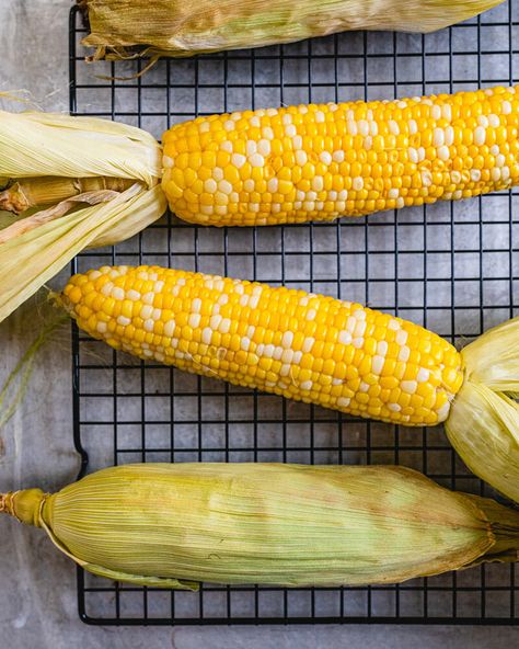 This oven roasted corn on the cob is the easy way to cook corn! You don't even have to remove the husk; just throw it right onto the oven grates. #corn #cornonthecob #cob #oven #corninoven #sidedish #easy Roasted Corn On The Cob, Corn In The Oven, Oven Roasted Corn, Cook Corn, Cob Oven, Winter Salad Recipes, A Couple Cooks, How To Cook Corn, Healthy Cook Books