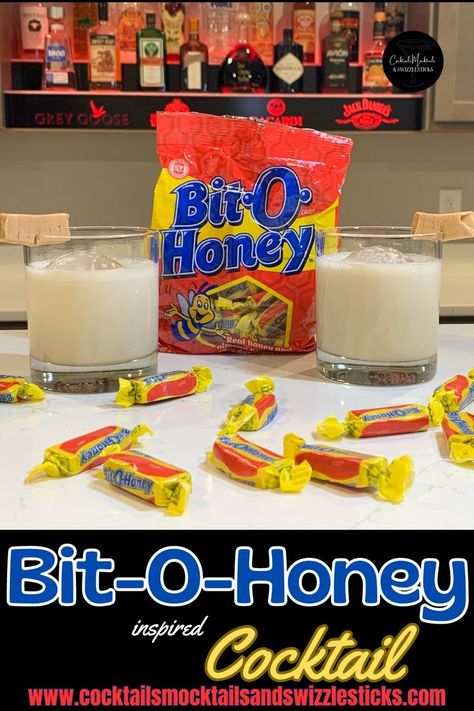 This image shows two cocktails with a bit-o-honey garnish in front of a bag of bit-o-honey candy with bit-o-honey candies scattered in front. Bit O Honey Recipe, Bit O Honey, Honey Cocktail, Honey Drink, Honey Candy, Themed Drinks, Honey Recipes, Irish Whiskey, Dessert Drinks