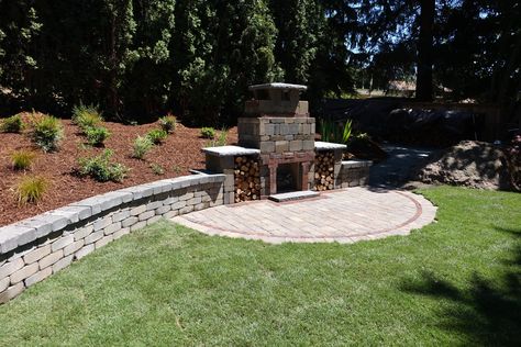 TuscanStone Fireplace with retaining wall and Dominion Slate Patio (project by Dreamscapes) Outdoor Fireplace In Retaining Wall, Outdoor Fireplace Built Into Retaining Wall, Retaining Wall With Fireplace, Retaining Wall Fireplace, Retaining Wall Fire Pit, Patio With Retaining Wall, Pilot View, Backyard Hill, Backyard Hill Landscaping