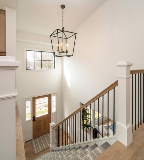 Stair Railing Ideas Modern Farmhouse, Split Level Railing Ideas Half Walls, Stair Chandelier Farmhouse, Raised Ranch Banister Ideas, End Of Hallway Picture Display, Entry Way Pendant Light, Classic Stair Railing Ideas, Transitional Style Staircase, Bilevel Entryway Ideas