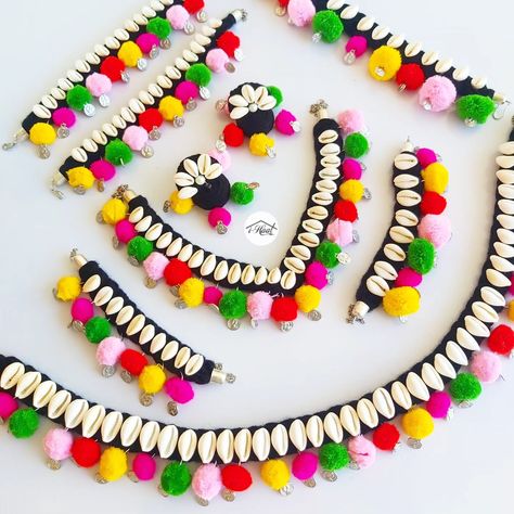 Are you planning for your navratri look in advance but haven't finalized the Jewellery yet? Checkout this beautiful Multicolored jewellery set adorned with lots of Cowrie shells, coins and pom poms to match your Garba Vibes for this Navratri Season 🔥 Items included: ❤️ Necklace ❤️ Jhumka ❤️ Headband ❤️ 2 Bracelets ❤️ Anklets ❤️ Waist belt Visit indiashaat.com for more handmade jewellery options #indiashaat #navratrijewellery #bohojewellery #multicolourjewellery #dakla2 [Handmade ... Navratri Vibes, Navratri Look, Navratri Jewellery, Fabric Jewellery, Cowrie Shells, Cowrie Shell, Jewellery Set, Handmade Ornaments, Fabric Jewelry