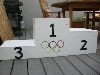 pretend olympic podium Team Olympic Games Party Ideas, Olympic Float Ideas, Olympic Trunk Or Treat, Olympic Parade Float Ideas, Olympic Vbs Decorations, Olympics School Theme, Olympic Podium Diy, Olympic Decorations, Olympic Theme Decorations