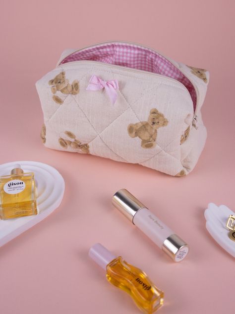 Add a touch of whimsy to your beauty routine with this charming handmade quilted makeup bag featuring an adorable teddy bear print. The delicate pink bow detail and the durable quilted design make this bag perfect for storing all your beauty essentials. Ideal as a personalized gift for her, whether it's for Mother's Day, a birthday, or just because. This versatile toiletry makeup bag is also great for travel, keeping your cosmetics organized in style. Treat yourself or a loved one to this unique Makeup Bag Personalized, Kawaii Pouch Cosmetic Bag Perfect For Gifts, Cute Heart Makeup Bag, Pink Kawaii Cosmetic Bag For School, Cheap Kawaii Style Cosmetic Bag, Handmade Makeup Bag, Sewing Aesthetic, Versatile Pink Cosmetic Bag For On-the-go, Personalized Cosmetic Bags