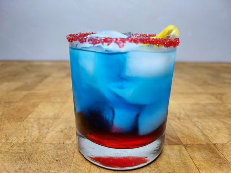 This superhero themed superman cocktail is a fun and colorful layered drink. It is bright blue and red colored. Vodka Sprite, Rainbow Cocktail, Vodka Punch, Brandy Cocktails, Layered Drinks, Cocktail Shots, Popular Cocktails, Vodka Soda, Vodka Cocktails Recipes