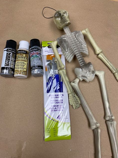 Dollar Tree Skeleton Makeover - The Shabby Tree Skeleton Tree Topper, Dollar Store Skeleton Crafts, Dollar Tree Wood Skeleton Crafts, Dollar Tree Skeleton Diy, Skeleton Crafts For Adults, How To Age A Plastic Skeleton, Decorating Skeletons, Plastic Skeleton Crafts, Decorated Skeletons