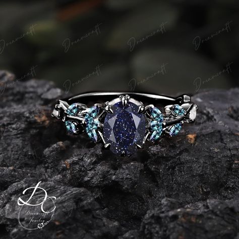 Gothic Black Gold Oval Cut Blue Sandstone Engagement Ring Bridal Ring Nature Inspired Cluster Promise Ring  Art Deco Leaf Gemstone Branch --->Ring details: - Theme:Romantic Wedding & Engagement - comfortable band - Metal :The underneath metal is in Silver/ 10K/14K/18K white gold, coated with black rhodium - Center Stone : Blue Sandstone - Carat: 6*8mm - Side stone : Lab alexandrite +  moissanite - Side stone:0.48ctw - wedding band :Lab alexandrite  + lab opal +moissanite - 0.12ctw  Materials: - Engagement Ring Sets, Emerald Engagement Ring Set, Nature Engagement Ring, Band Metal, Alexandrite Engagement Ring, Gold Engraving, Ring Art Deco, Emerald Engagement, Schwarz Gold