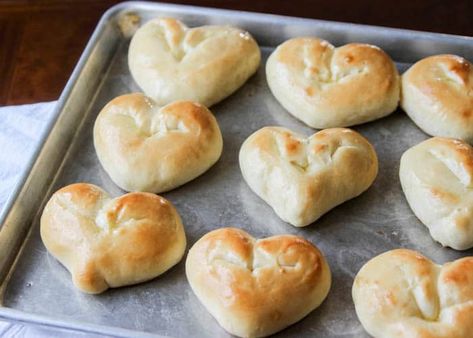 Follow these step-by-step instructions for easy heart shaped dinner rolls - perfect for Valentine's Day!  Every year for Valentine's day we do a heart themed meal for our family dinner. These Valentine's dinner rolls have become my new go-to because they are so easy and my girls think they are just about the best things ever. Because what little girl doesn't love heart shaped food?? Am I right?! Let's get started! Valentine Heart Shaped Dinner Rolls Begin by preparing your... Valentine Bread, Heart Shaped Food Valentines, Heart Shaped Dinner, Shaped Dinner Rolls, Bread Tutorial, February Inspiration, Valentine's Dinner, Heart Shaped Food, Valentine's Party