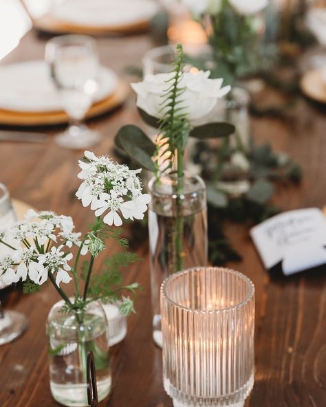 Sweet little bud vases are a great way to stretch your floral budget. Especially if you have a large guest count and need to decorate a large number of tables. ⠀⠀⠀⠀⠀⠀⠀⠀⠀ Photo by @kara_kamienski_photography at @thehesedhousevenue Bud Vases With White Flowers, Floating Candles And Bud Vases, Bud Vase And Candle Centerpiece, Ribbed Votives, Greenery Color Palette, Boho Spring Wedding, Candle Votive Centerpiece, Candle Table Runner, Bud Vases Arrangements