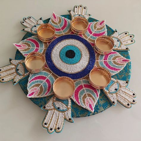 Evil eye Rangoli with hamza on the mdf base of 10"  DM us for more details or WhatsApp us on 9867422790 Evil Eye Rangoli Designs, Mdf Rangoli Designs, Diwali Embroidery, Arti Decoration, Wedding Rukhwat, Diya Candle, Evil Eye Decoration, Subh Labh, Diwali Items