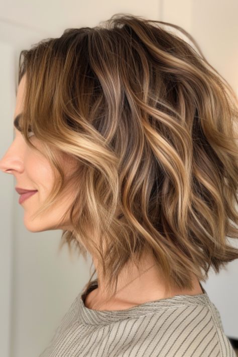 A mid-length layered bob with beach waves delivers a youthful and relaxed vibe. The layers add much-needed texture, and the beach waves exude casual charm. Click here to check out more flattering medium-length haircuts for women over 40. Bob With Beach Waves, Blonde Styles, Haircuts For Women Over 40, Short Hair Cuts For Round Faces, Short Hair Waves, Medium Hair Styles For Women, Layered Haircuts For Medium Hair, Beach Wave Hair, Shoulder Hair