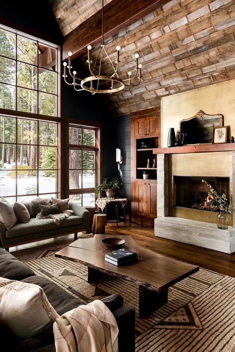 Soaring, barn-wood–clad ceilings and massive windows meet dark, moody colors for a cocoon-like feel in this Lake Tahoe cabin. Hunting Cabin Interior Living Room, Lake Tahoe Homes Interior, Dark Moody Cabin Interior, Dark Cozy Cabin Interior, Wooden Cabin Interior Design, Dark California Cool Interior, Moody Log Cabin Interior, Moody Mountain Living Room, Relaxed Elegance Interior Design