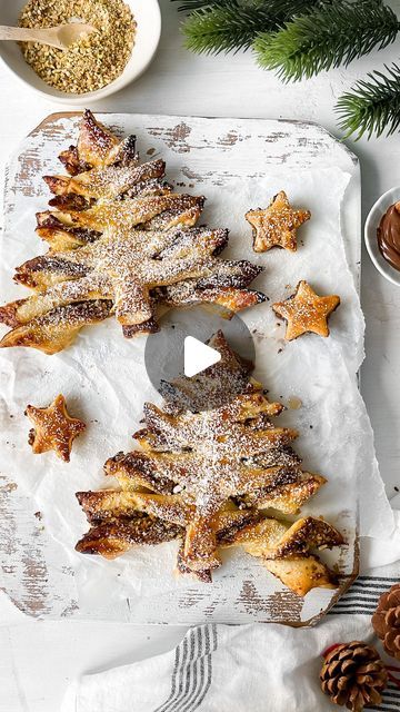 Kristel Talie on Instagram: "Nutella Baklava Christmas Trees✨

The perfect Christmas treat! It’s filled with Nutella, crushed nuts and finished with a drizzle of simple honey syrup.

Ingredients:
2 puff pastries

For the filling:
1 cup Nutella, slightly melted
1/2 cup crushed nuts (almonds, walnuts, pistachios)
1/4 tsp cinnamon
Small pinch of salt

Bake on 200C for 10 minutes or until slightly golden.

Honey syrup:
2-3 tbsp honey
1 tbsp water
(Bring to a simmer in a small saucepan until the honey melts. Set aside to cool before drizzling)
.
.
.
.
.
.
.
.
.
.
#christmasbaking #nutella #nutellatree #dessert #christmasrecipes #easyrecipes #chocolatebaklava #baklava #recettenutella #recettenoel #patefeuilletee #dessertnoel #recettefacile #mangerequilibre #nicefrance #cotedazur #dessertreels #f Nutella Baklava, Chocolate Baklava, Puff Pastries, Honey Syrup, Golden Honey, Christmas Treat, The Perfect Christmas, Pinch Of Salt, Baklava