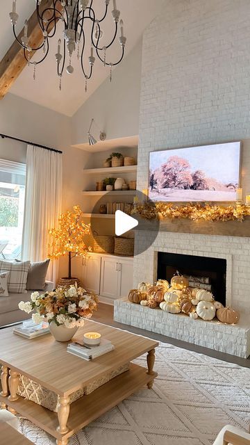 Erin Vogelpohl on Instagram: "What do you do with your fireplace when it’s fall but it’s also 95° outside…you create a pretty pumpkin display! 🎃 Comment “Links” and I’ll send you the links for my living room fall decor. We definitely won’t miss using the fireplace since it won’t get cold here for probably 2 more months! 🤷‍♀️😁  If you’re wondering these are a mix of faux and real pumpkins. It’s nice to work with both because the real pumpkins are just so gorgeous but the faux pumpkins are light and able to be positioned easily. I used these super inexpensive stems from Walmart to create my maple leaves mantel garland…I’ll link them! And you’re getting a peek at the end at one of the gorgeous new “crochet” style rugs we are launching in October! I’ll sharing a better look at all the new r White Fireplace Fall Decorations, Tv Entertainment Center Fall Decor, Fall Decor For Entertainment Center, Fall Electric Fireplace Decor, Fireplace Filled With Pumpkins, Room Fall Decor, Real Pumpkins, Mantel Garland, Pumpkin Display