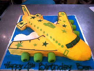 3D Airplane shaped cake iced in yellow butter icing decorated with green stars | by Charly's Bakery Planes Birthday Cake, Airplane Birthday Cakes, 3d Airplane, Stone Age Man, Planes Birthday Party, Airplane Cake, Planes Birthday, Flying In The Sky, Airplane Birthday Party