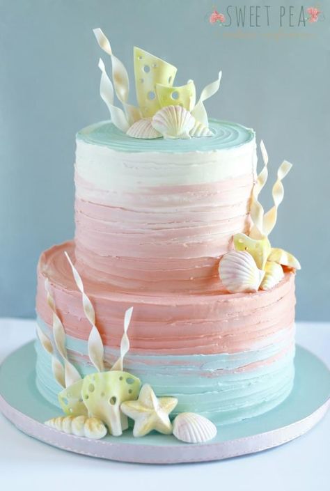 This ombré cake was made for an underwater themed baby shower. It’s a beautiful technique to use, especially for cakes that are very light and airy. Pink Under The Sea Cake, Coral Cake Ideas, Shell Birthday Cake, Sea Cake Ideas, Seashell Birthday Cake, Beach Cake Ideas, Beachy Cake, Teal Cake, Beach Birthday Cake