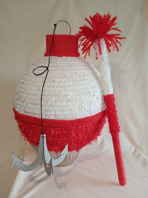 Do you have a fishing addict around? :) You will definitely need this Fishing Bobber pinata then - it will brighten your Fishing themed party! Isn't it nice? :) The Bobber pinata is a lovely addition and a great fun for a birthday kid as well as for the guests. This listing is for a Large sized pinata. Diameter - near 18 in (45cm). Round shape. The pinata can hold up to 7 pounds of candies and party favors (not included).  Lots of room to put plenty of goodies! Easy to load through a special pre How To Make A Fish Pinata, Bobber Pinata, Fishing Pinata, Boys Pool Party Ideas, Lake Birthday Party Kids, Fishing Birthday Party For Men, Fish Party Ideas, Fishing Party Theme, Fish Pinata